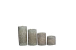 Set of four textured pillar candles in varying heights, perfect for home decor and relaxation.