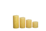 Set of four scented pillar candles in varying heights, for spa, candle light dinners and more.